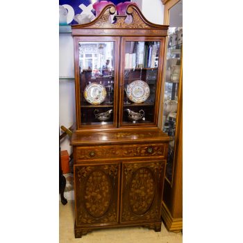 Neat marquetry inlaid mahogany bookcase with scroll top. Measures 75w x 43d x 181h cm. Price includes nationwide delivery
