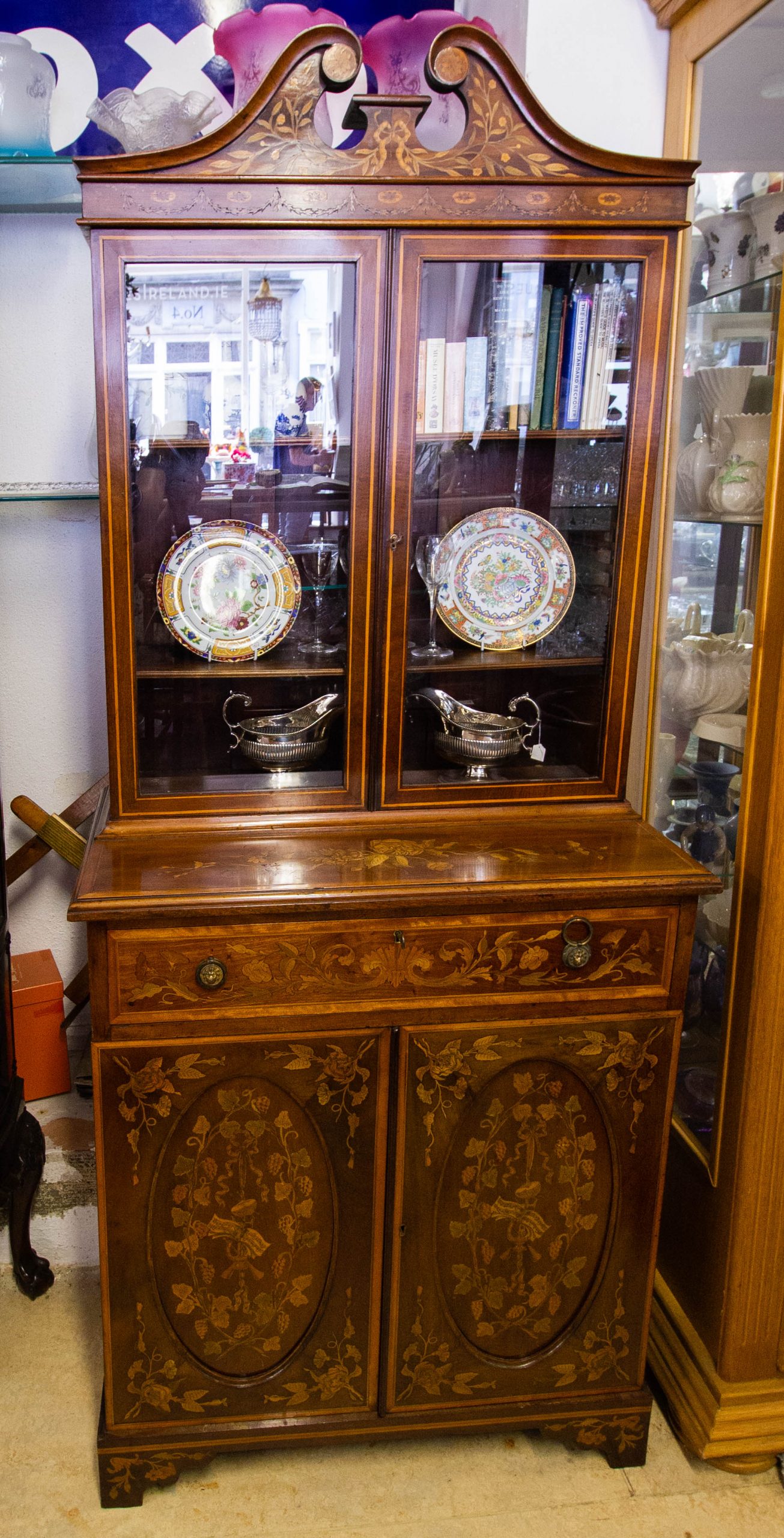 IMG_3672 Neat marquetry inlaid mahogany bookcase with scroll top. Measures 75w x 43d x 181h cm. Price includes nationwide delivery