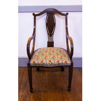 Oak elbow occasional chair with tulip upholstered seat. Measures 47W x 48D x 40H (seat), 89H (back). Price includes nationwide delivery